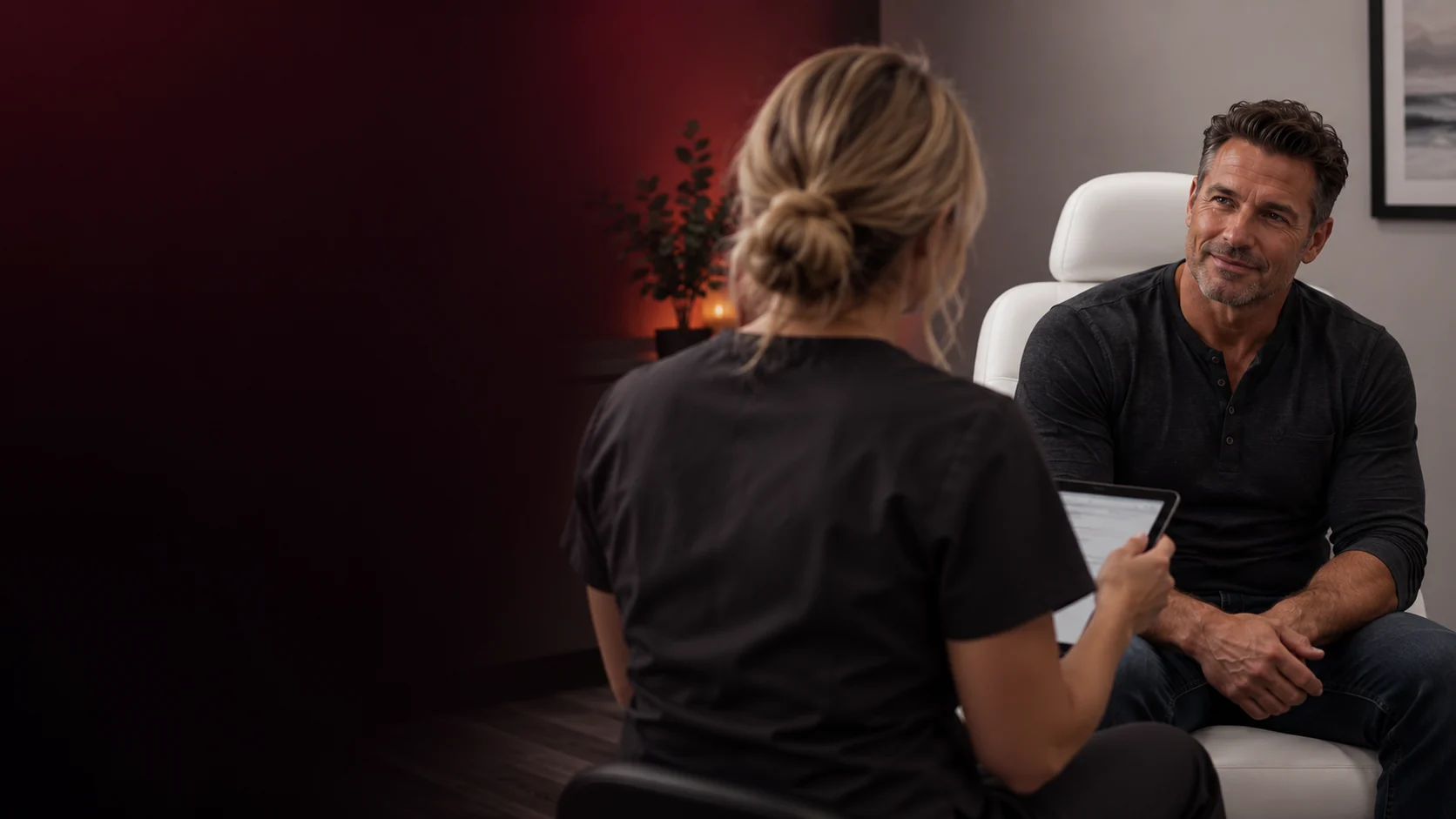Male patient consulting with a provider holding a tablet about testosterone replacement therapy.